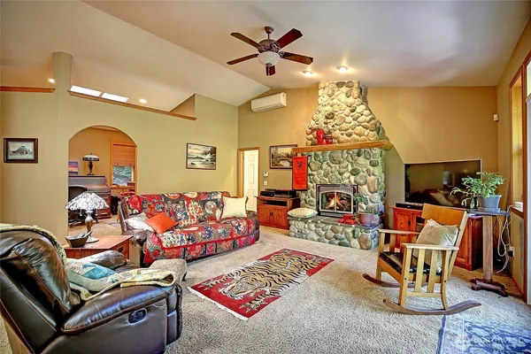 a living room with patio furniture and a chandelier