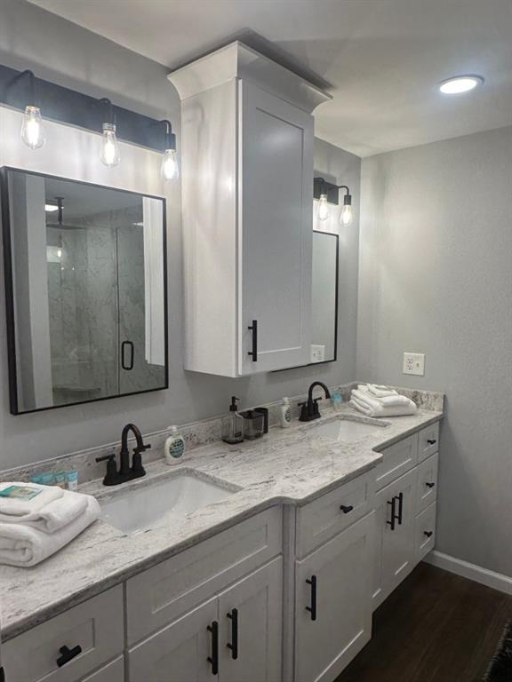 172 Thompson Place Gainesville, GA 30506 - Photo 21 of 32 a bathroom with double sink and a mirror