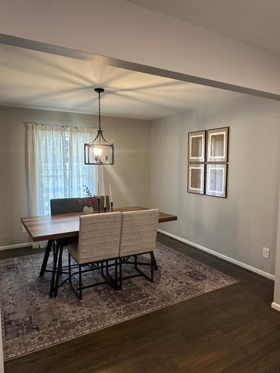 172 Thompson Place Gainesville, GA 30506 - Photo 4 of 32 a dining room with wooden floor a glass table and chairs
