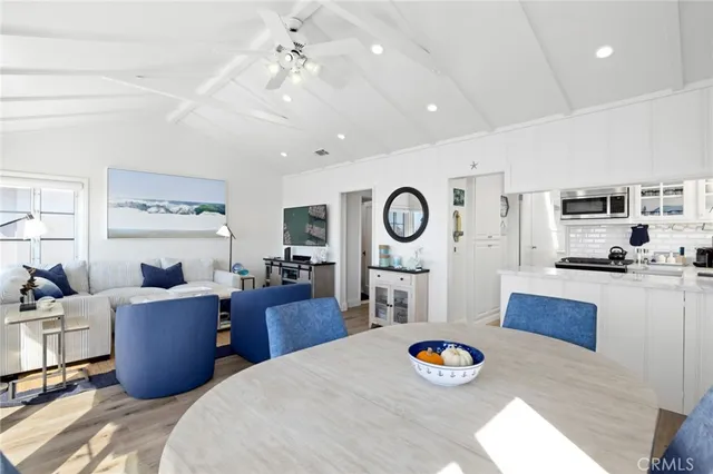 a living room with furniture and kitchen view