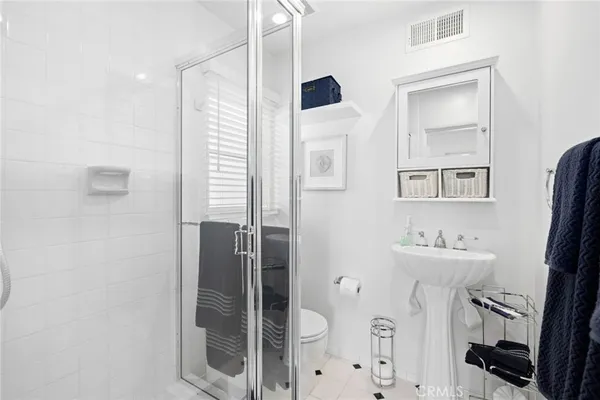 a bathroom with a sink a mirror and shower