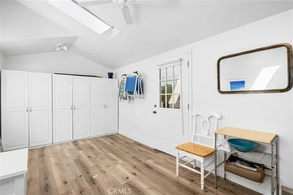 a bedroom with furniture and a wooden floor