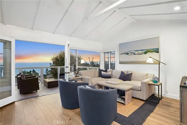 a living room with furniture and a floor to ceiling window