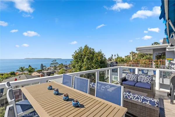 a view of a balcony with wooden floor and outdoor seating