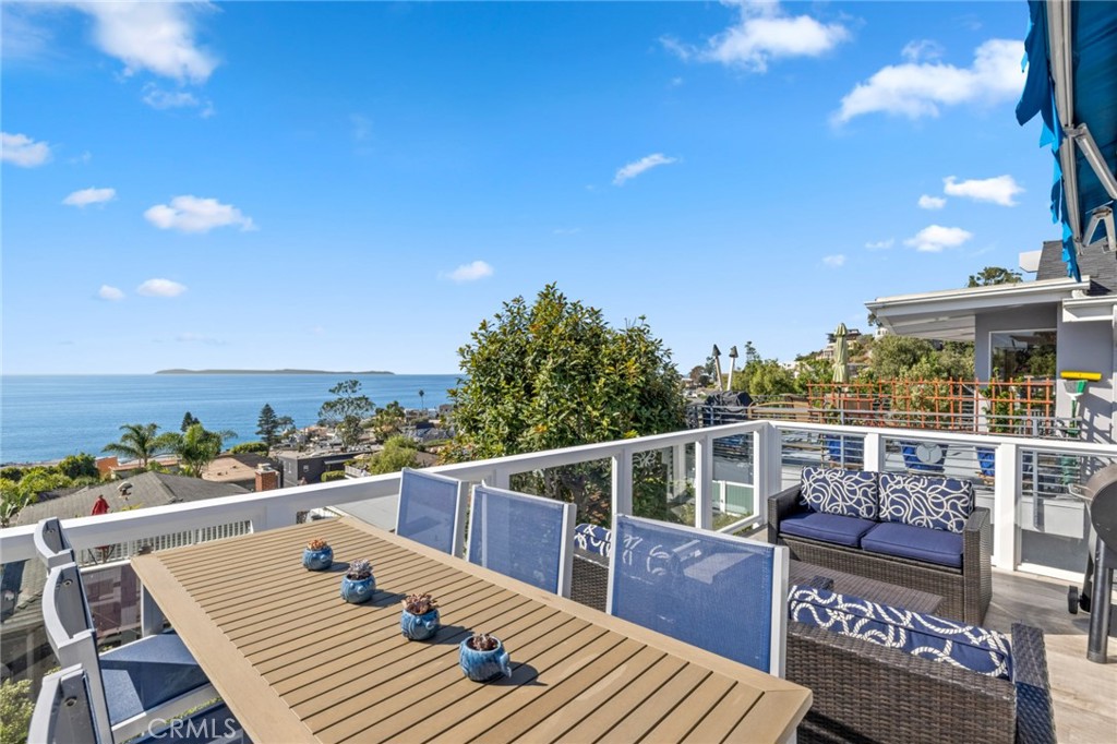 2915 Rounsevel Terrace Laguna Beach, CA 92651 - Photo 5 of 32 a view of a balcony with wooden floor and outdoor seating