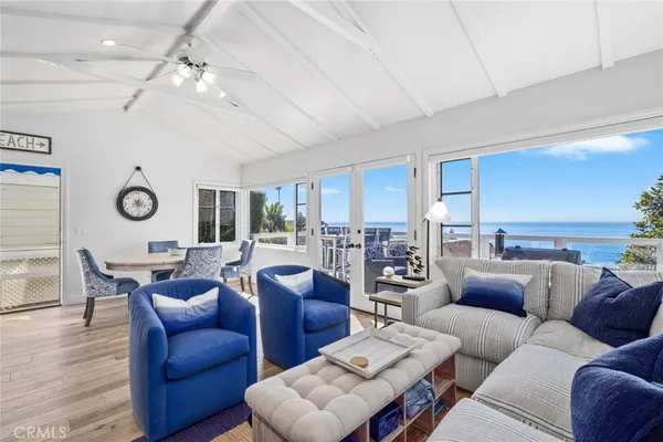 a living room with furniture kitchen view and a large window