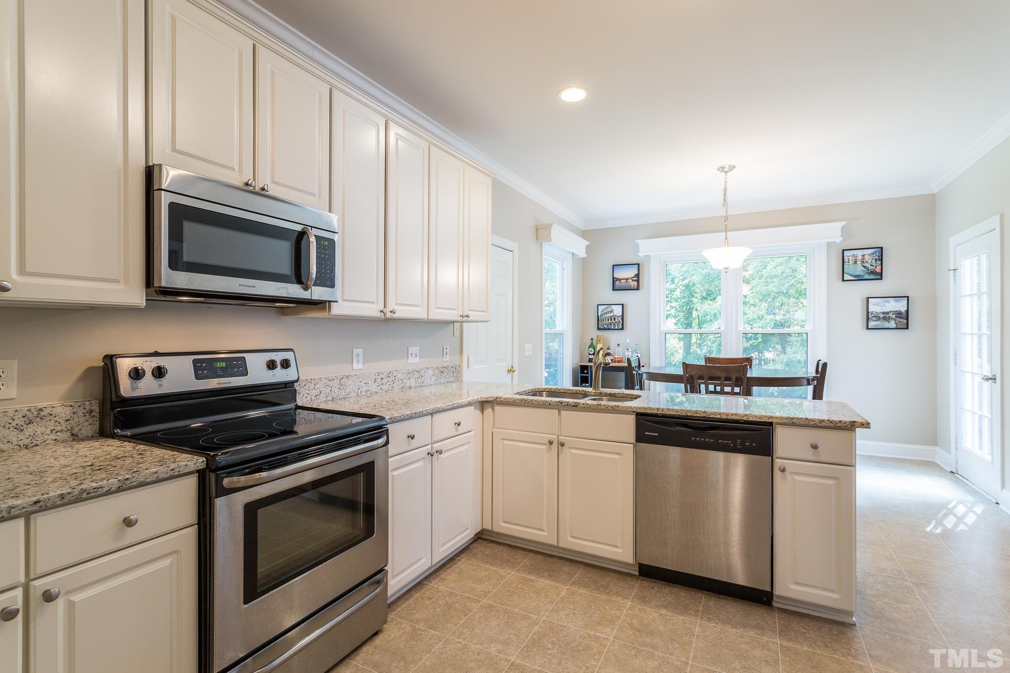 5225 Covington Bend Drive Raleigh, NC 27613 - Photo 12 of 30 a kitchen with granite countertop cabinets stainless steel appliances and a window