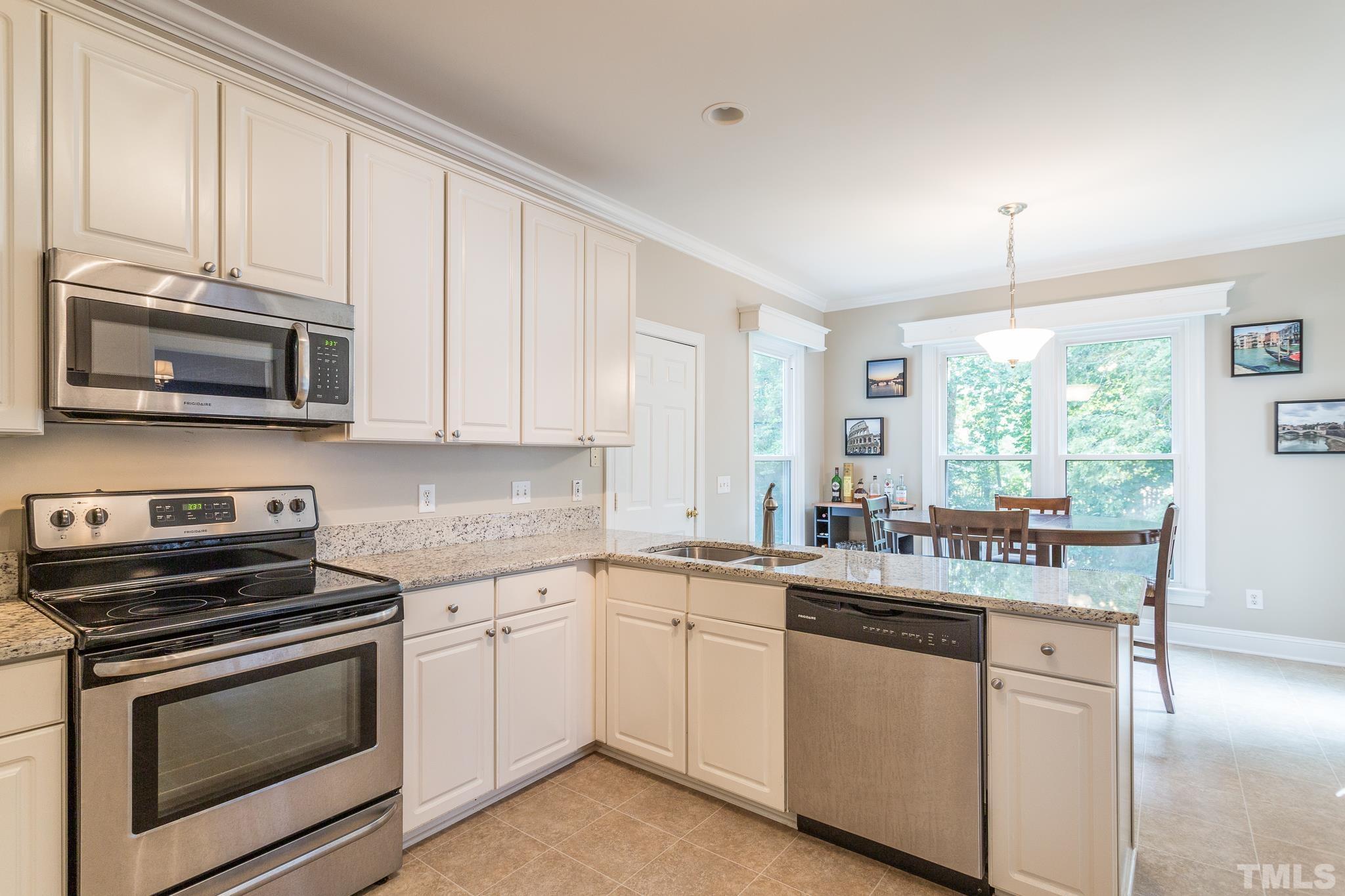 5225 Covington Bend Drive Raleigh, NC 27613 - Photo 13 of 30 a kitchen with a sink stove and microwave