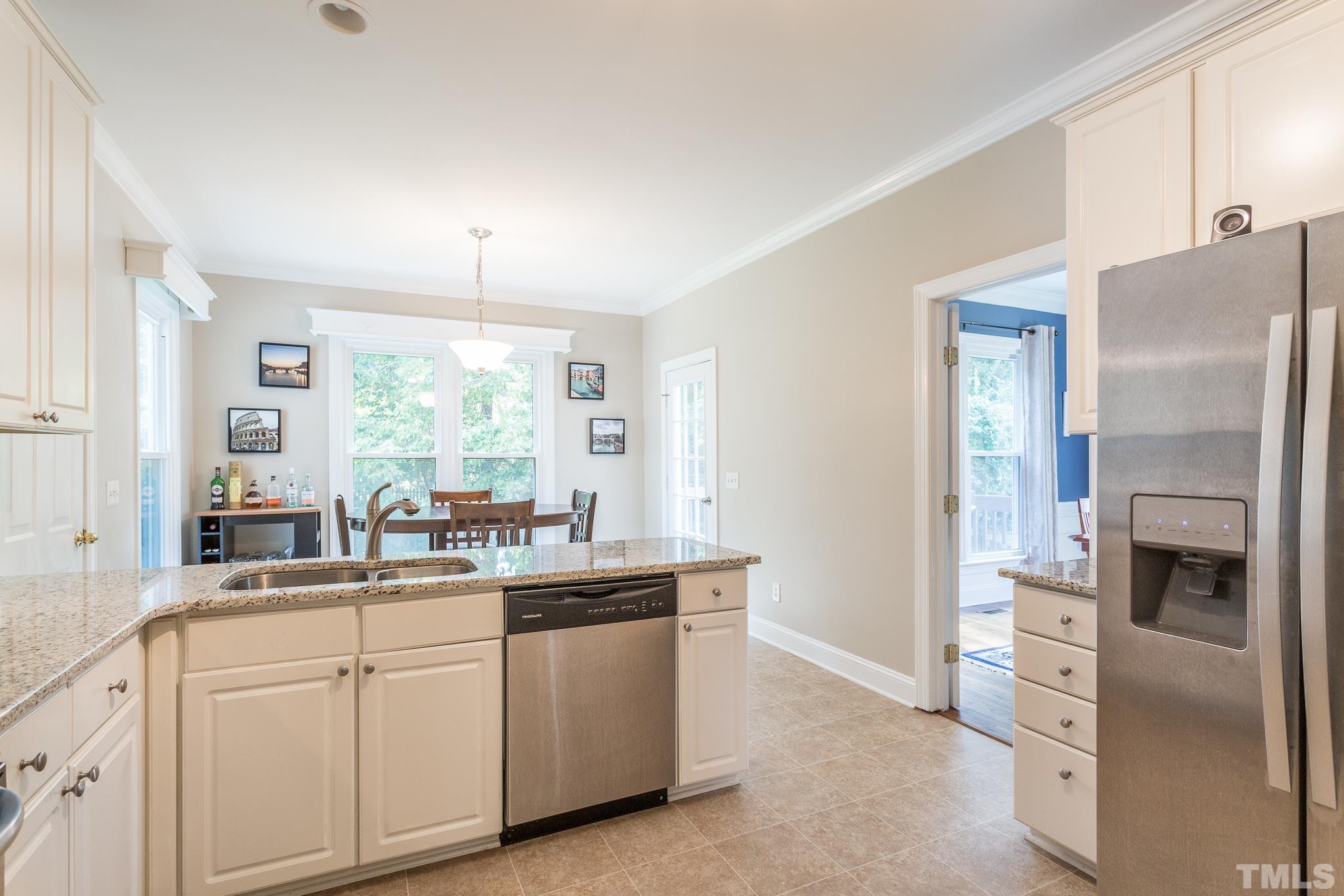 5225 Covington Bend Drive Raleigh, NC 27613 - Photo 14 of 30 a kitchen with white cabinets and white appliances