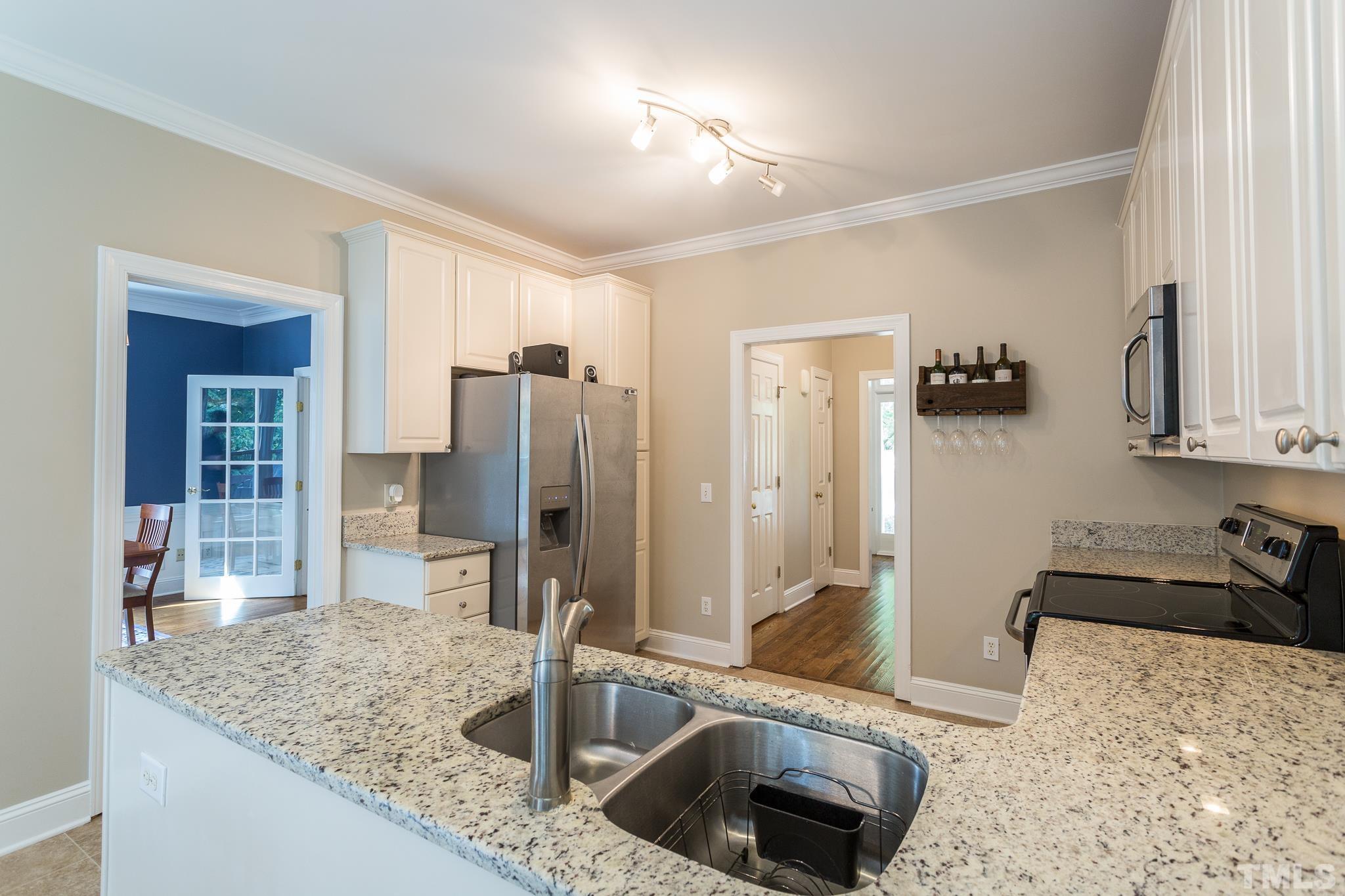 5225 Covington Bend Drive Raleigh, NC 27613 - Photo 16 of 30 a kitchen with granite countertop a sink a stove and refrigerator