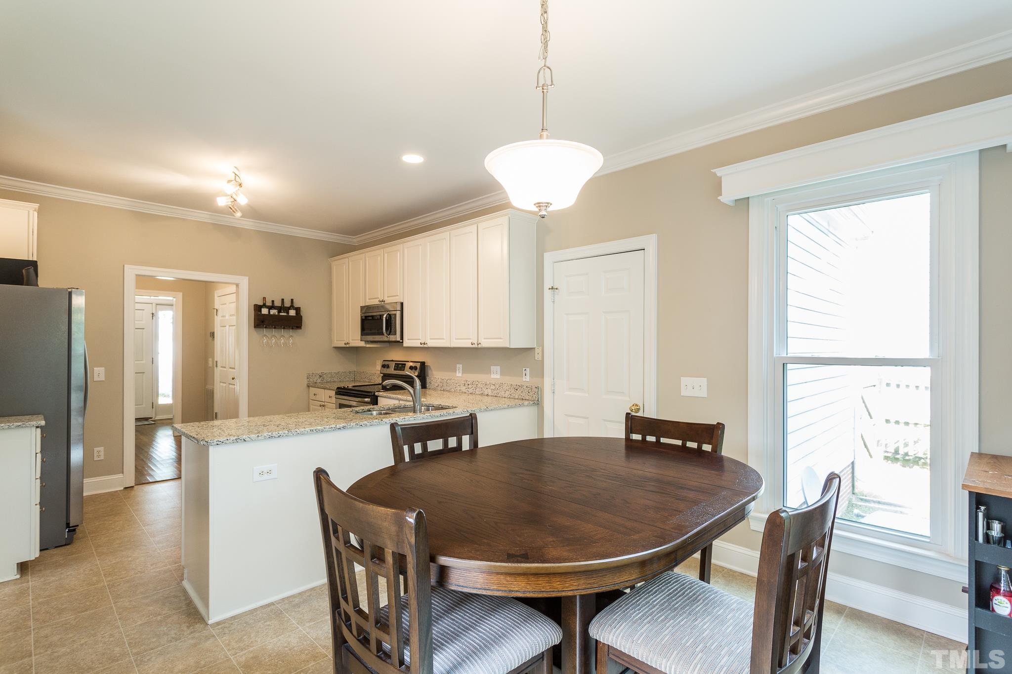5225 Covington Bend Drive Raleigh, NC 27613 - Photo 17 of 30 a large kitchen with a table and chairs in it