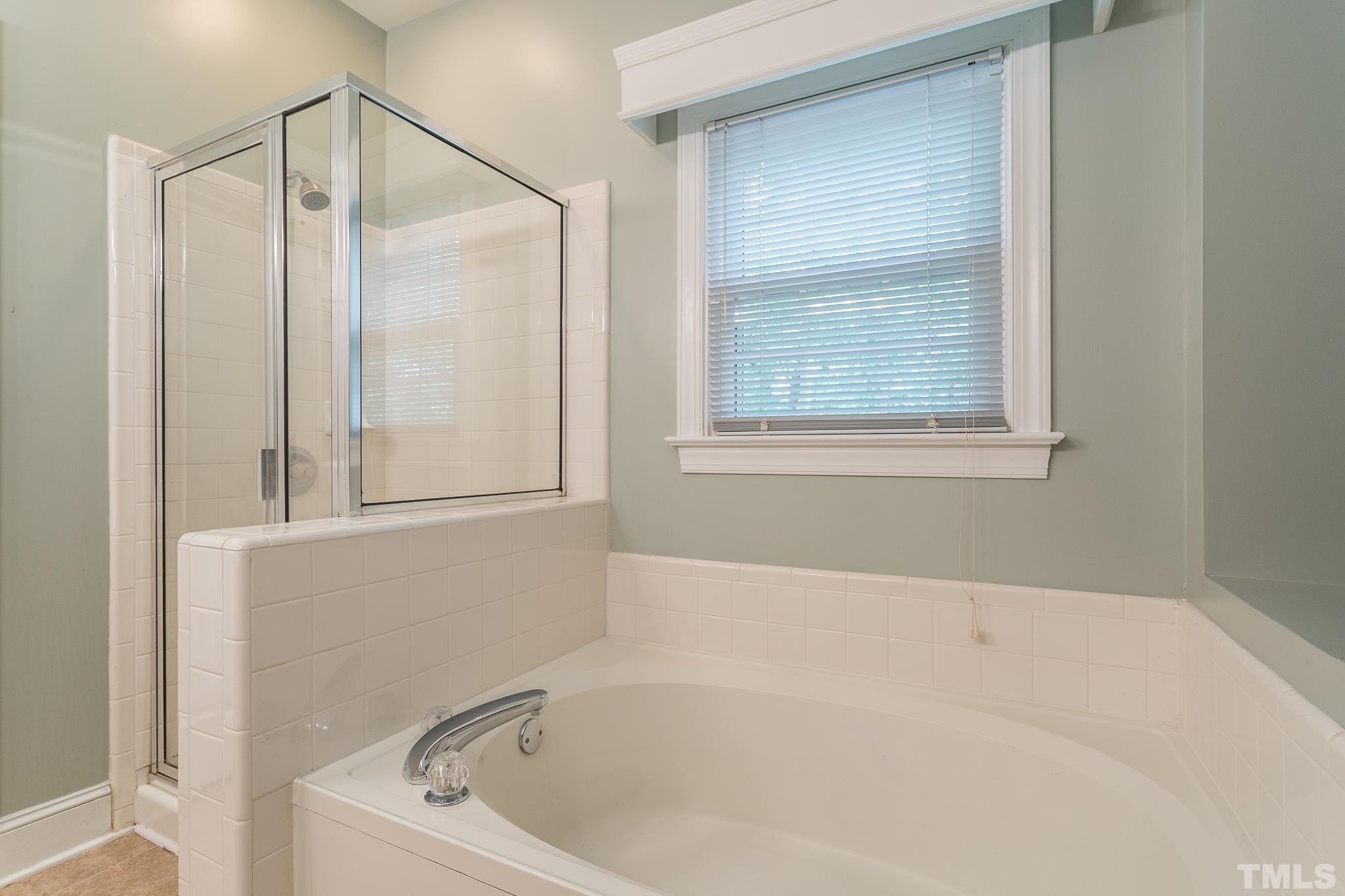 5225 Covington Bend Drive Raleigh, NC 27613 - Photo 22 of 30 a bathroom with a bathtub and a shower