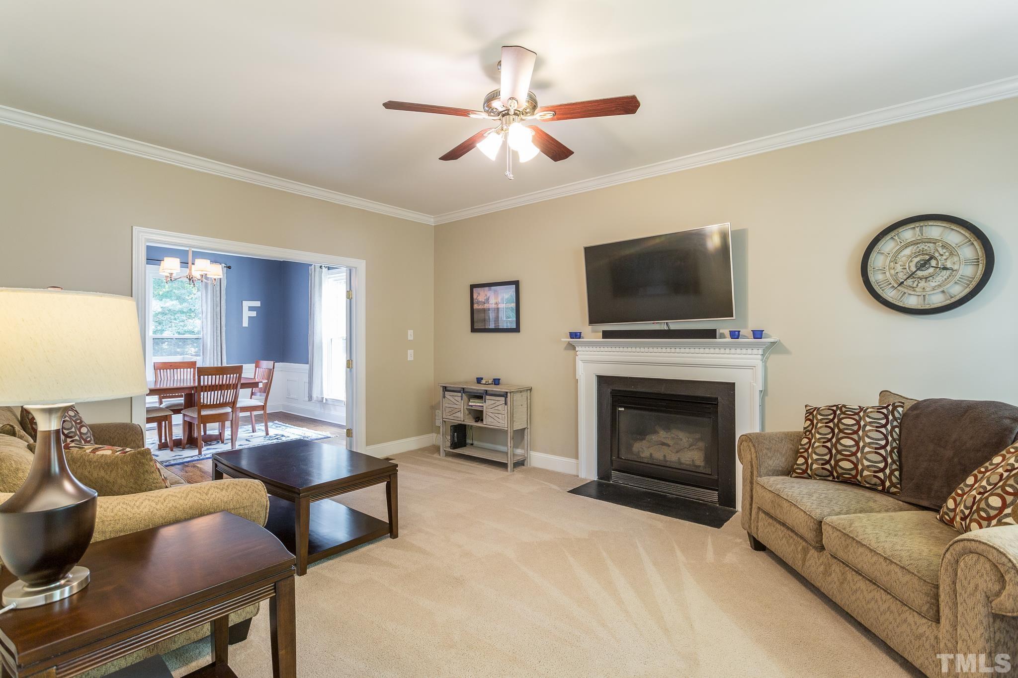 5225 Covington Bend Drive Raleigh, NC 27613 - Photo 5 of 30 a living room with furniture a flat screen tv and a fireplace