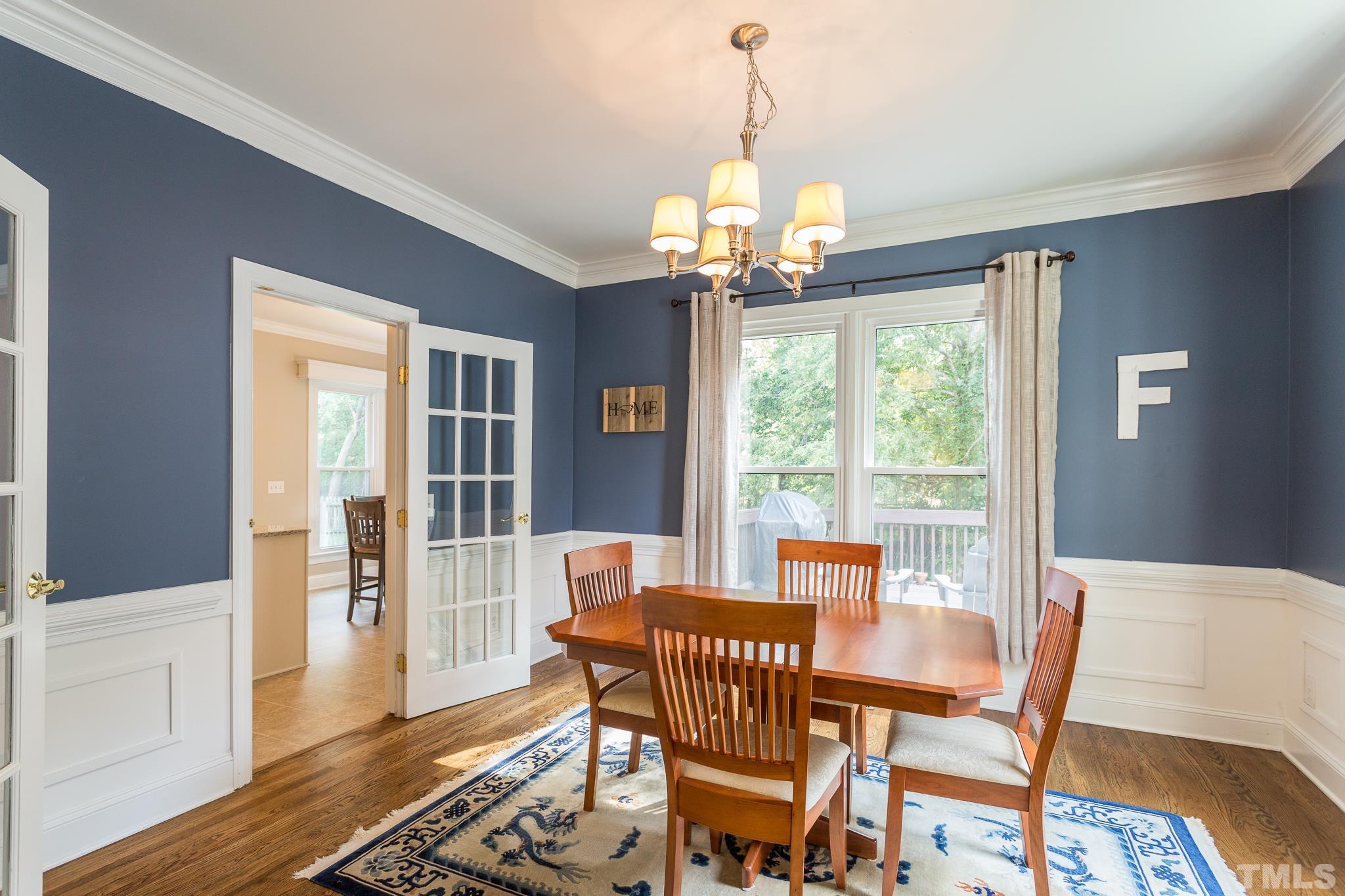 5225 Covington Bend Drive Raleigh, NC 27613 - Photo 9 of 30 a view of a dining room with furniture wooden floor and chandelier