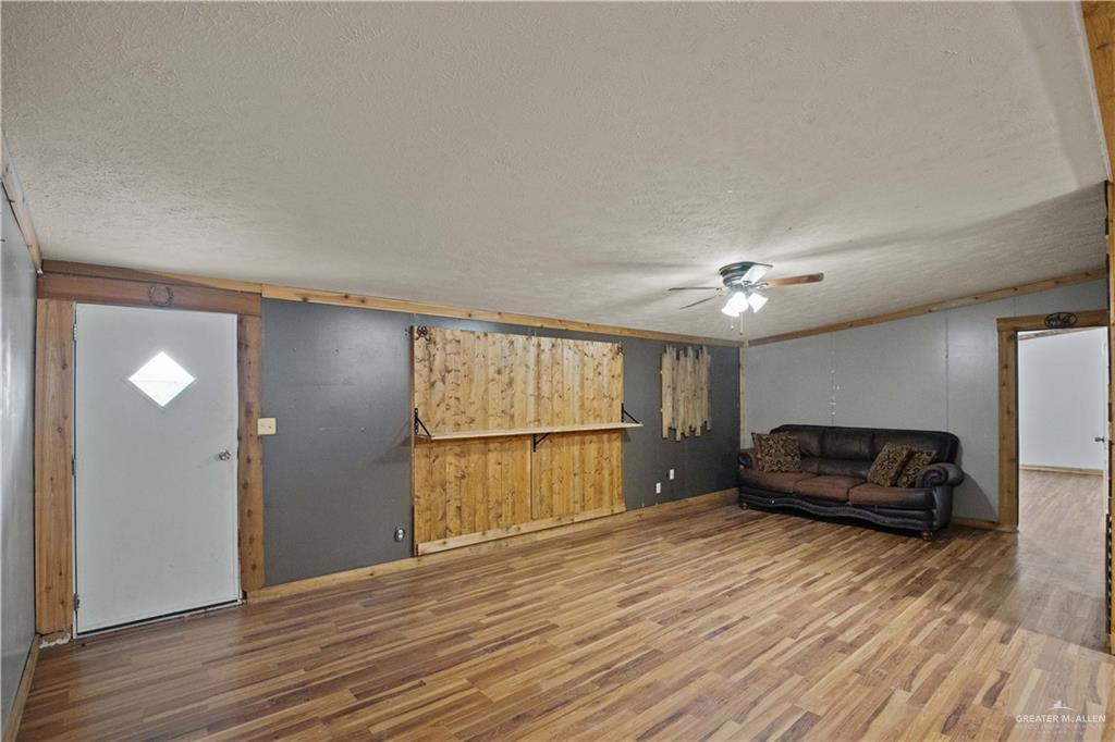 2209 Topacio Street Donna, TX 78537 - Photo 6 of 17 a living room with a couch and a wooden floor