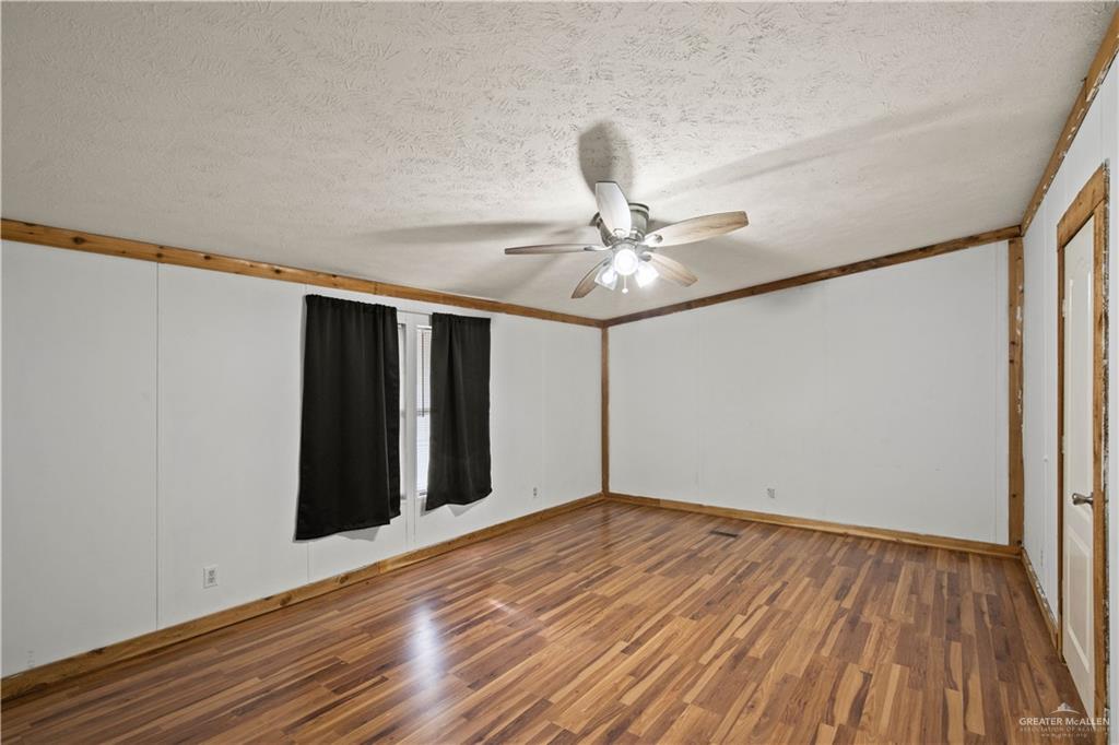 2209 Topacio Street Donna, TX 78537 - Photo 7 of 17 a view of an empty room with wooden floor