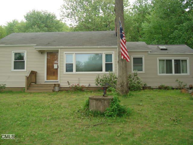 a view of a house with a backyard
