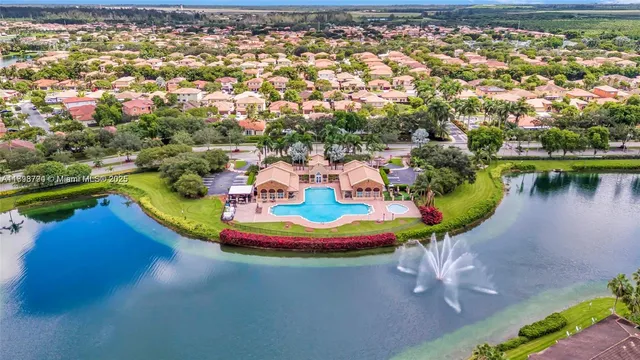 an aerial view of residential house with outdoor space pool patio and lake view