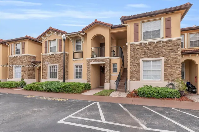 a front view of a house with a yard and a garage