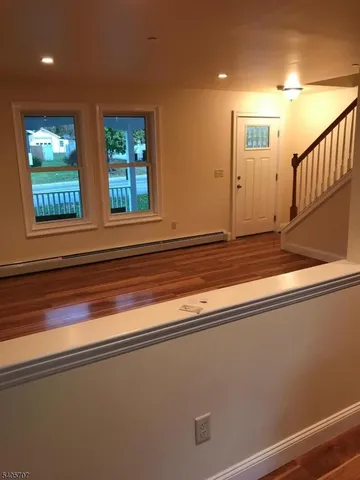 a view of room with window and refrigerator