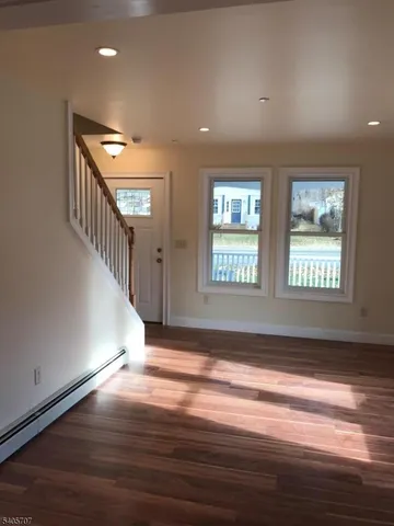 a view of an entryway with wooden floor