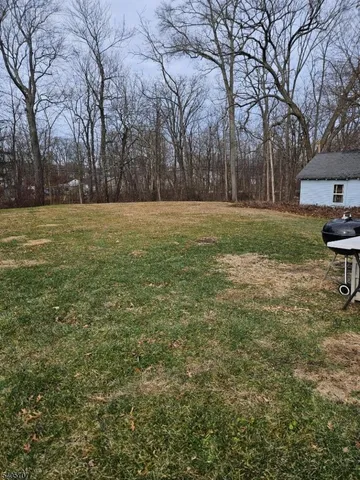 a view of outdoor space with deck and trees