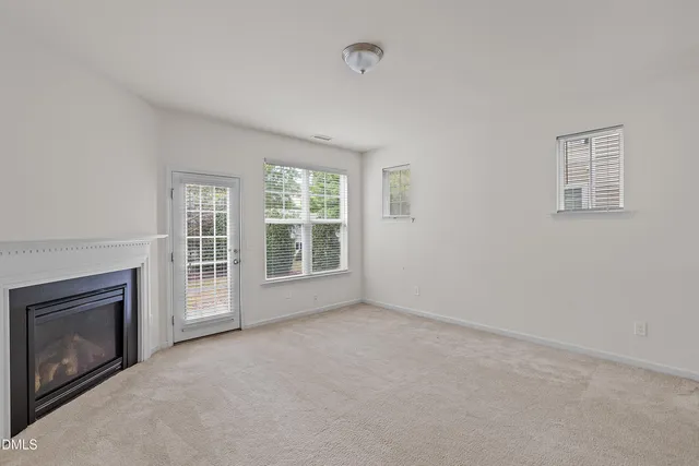 a view of empty room with a fireplace