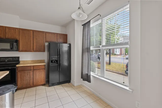 a kitchen with granite countertop a stove and a microwave