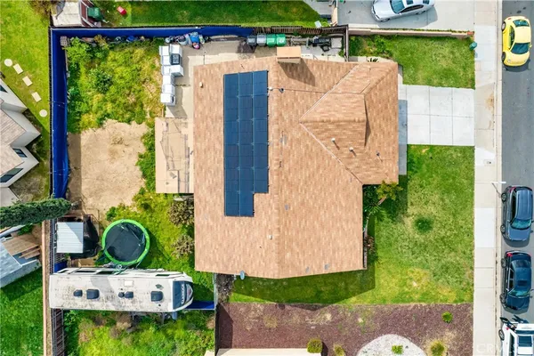 an aerial view of a house with swimming pool garden and patio