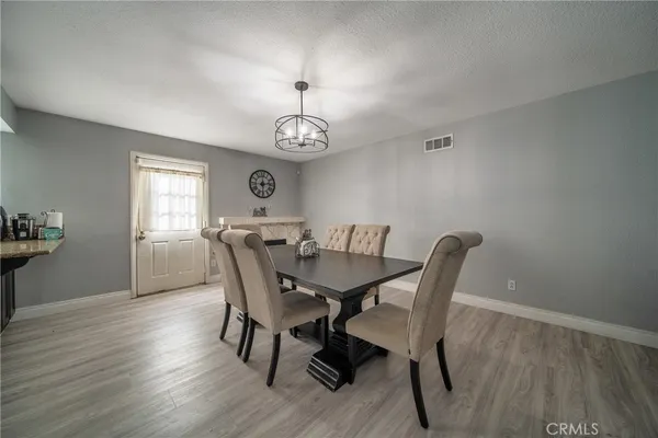 a view of a dining room with furniture wooden floor and chandelier