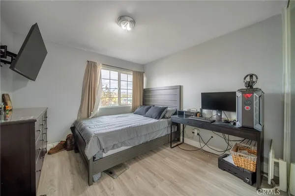 a bedroom with a bed and a flat screen tv