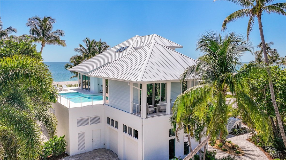 941 South Seas Plantation Road Captiva, FL 33924 - Photo 40 of 50 a view of house with swimming pool and glass windows