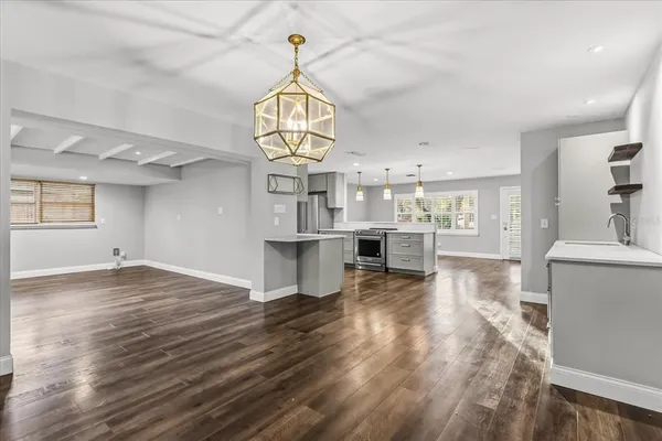 a view of a kitchen and wooden floor