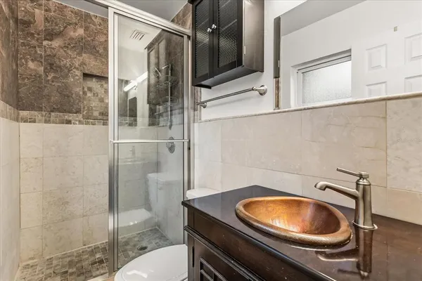 a bathroom with a sink toilet and shower