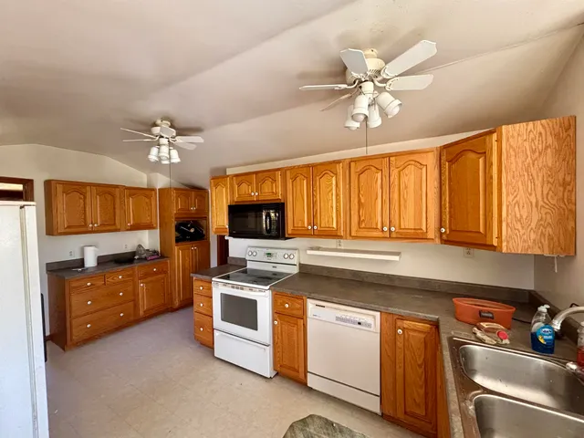 a kitchen with a stove a sink and a refrigerator