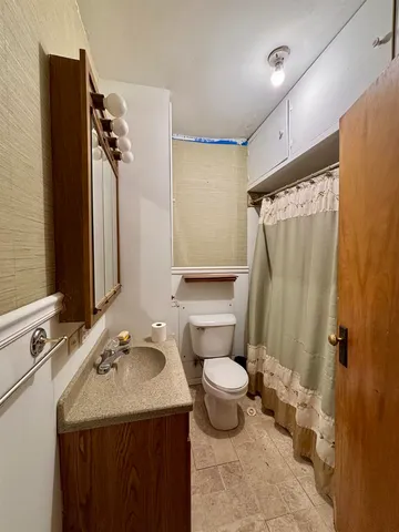 a view of a wooden house with a yard