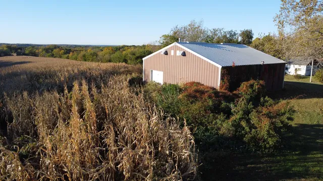 a view of a house with a yard and table under an umbrella