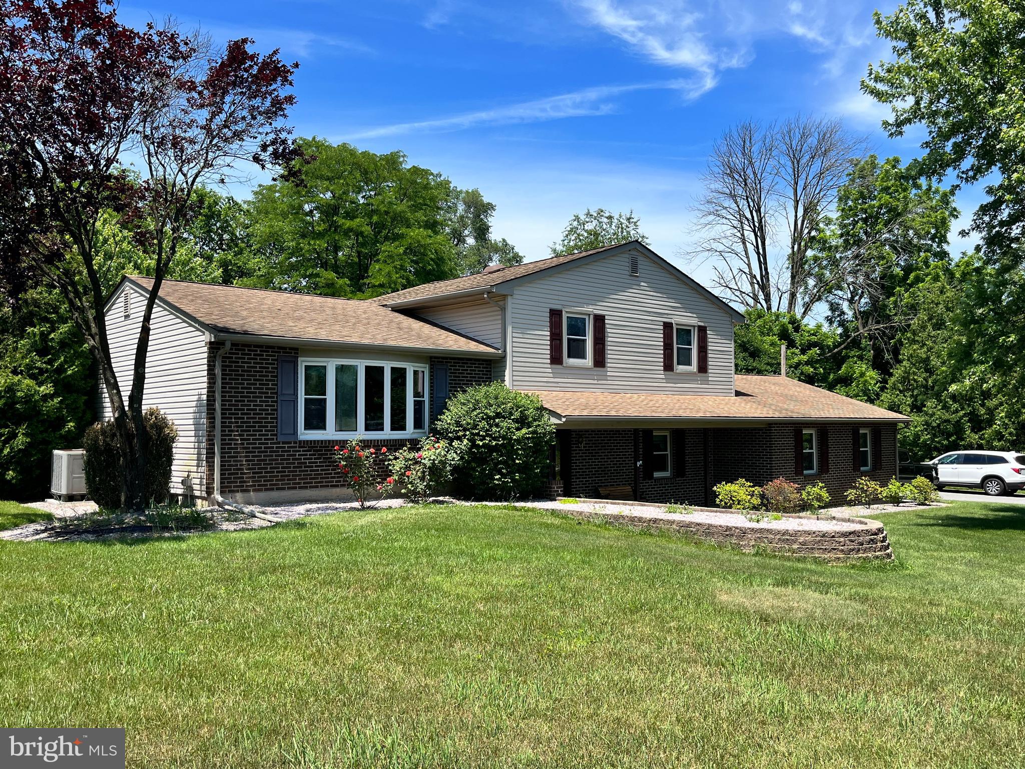 4067 East Texas Road Allentown, PA 18103 - Photo 1 of 37 a front view of a house with garden and trees