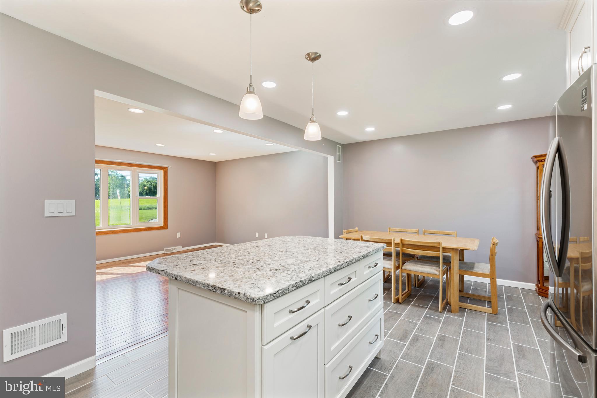 4067 East Texas Road Allentown, PA 18103 - Photo 11 of 37 a view of a kitchen with kitchen island a sink wooden floor and a refrigerator