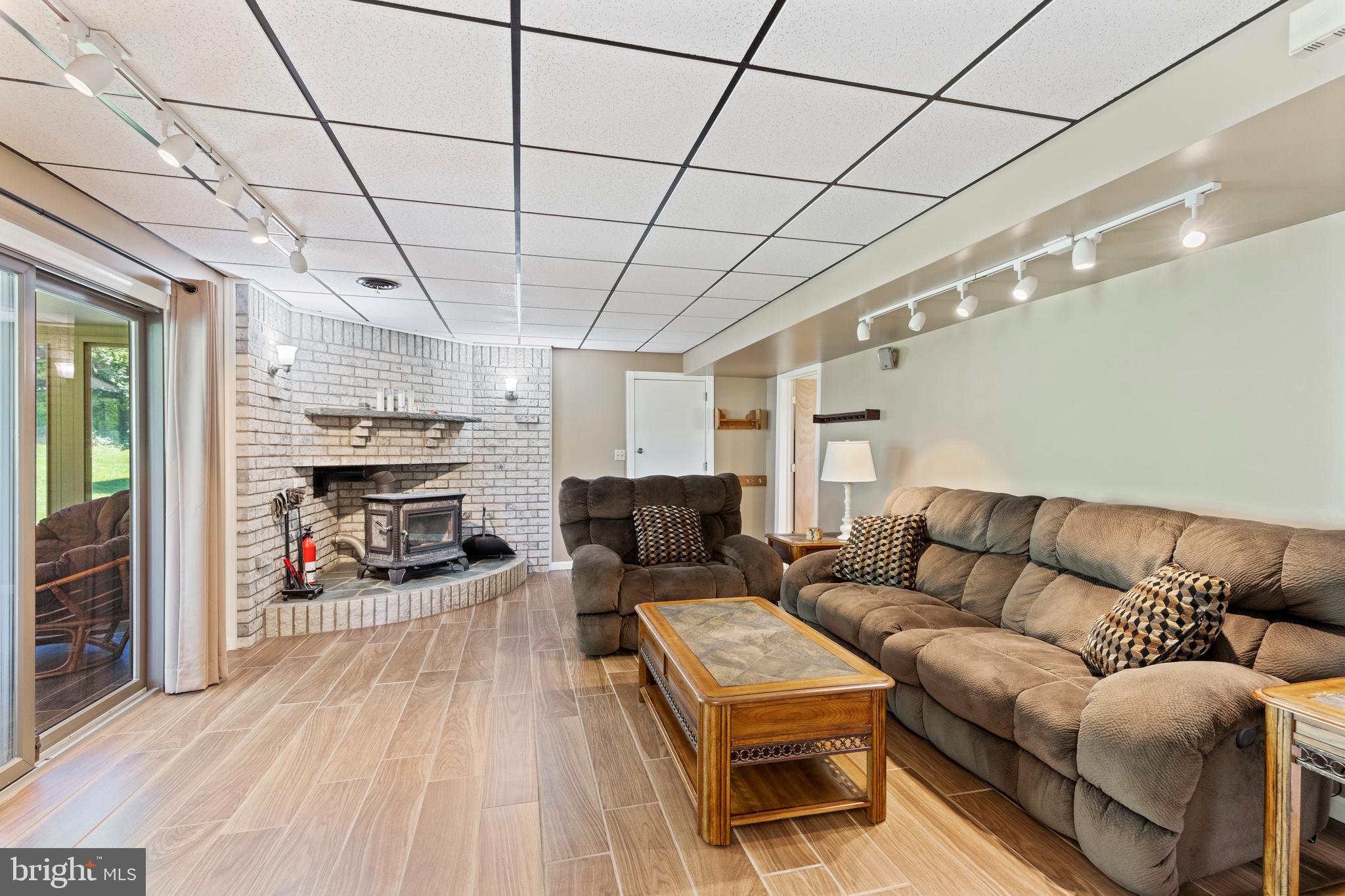 4067 East Texas Road Allentown, PA 18103 - Photo 25 of 37 a living room with furniture a fireplace and a flat screen tv