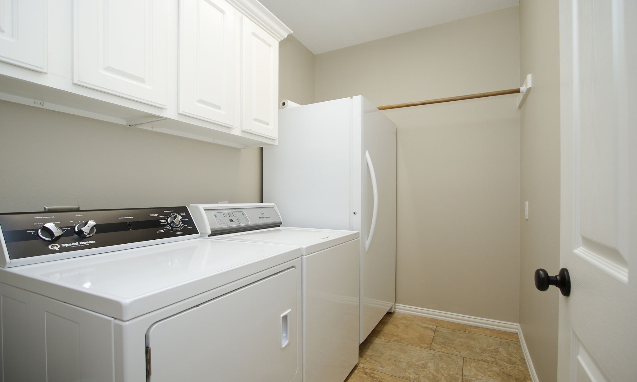 20110 Stormy Pine Lane Spring, TX 77379 - Photo 18 of 44 Utility room sits directly off the kitchen and provides plenty of space for those everyday laundry needs.