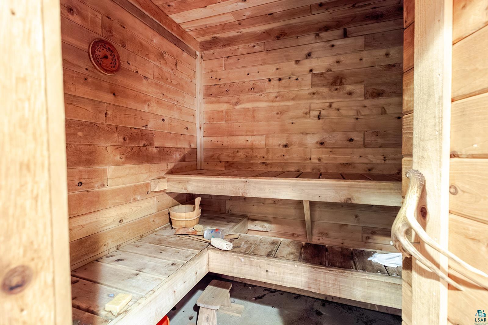 7045 Morris Thomas Road Cloquet, MN 55720 - Photo 26 of 28 Wood-paneled interior featuring a built-in bench