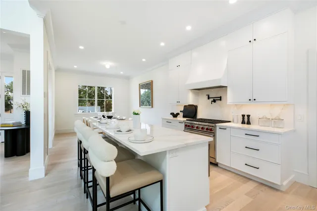 a kitchen with a stove a sink a dining table and chairs