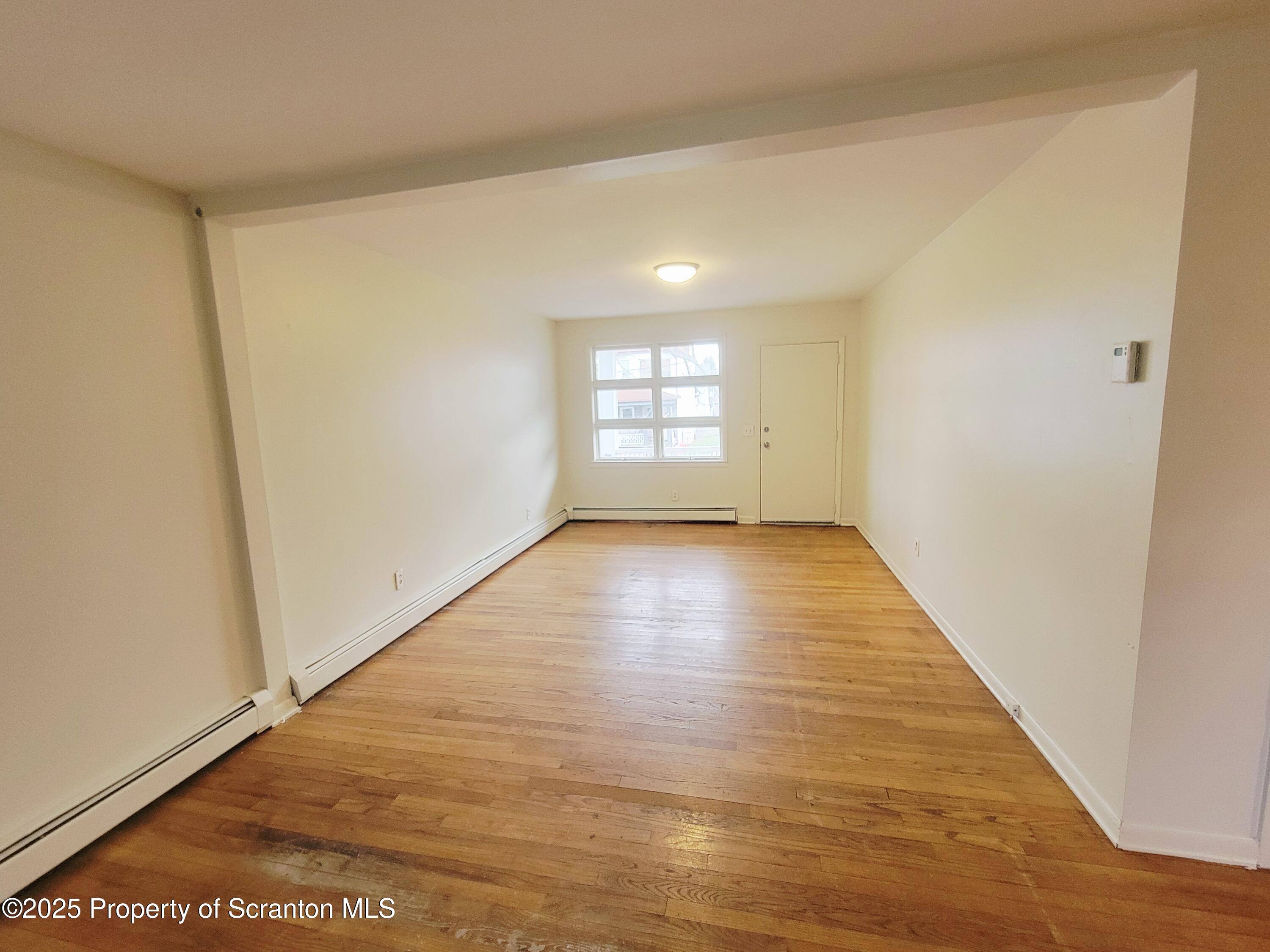 940 East Elm Street Scranton, PA 18505 - Photo 2 of 10 a view of empty room with wooden floor