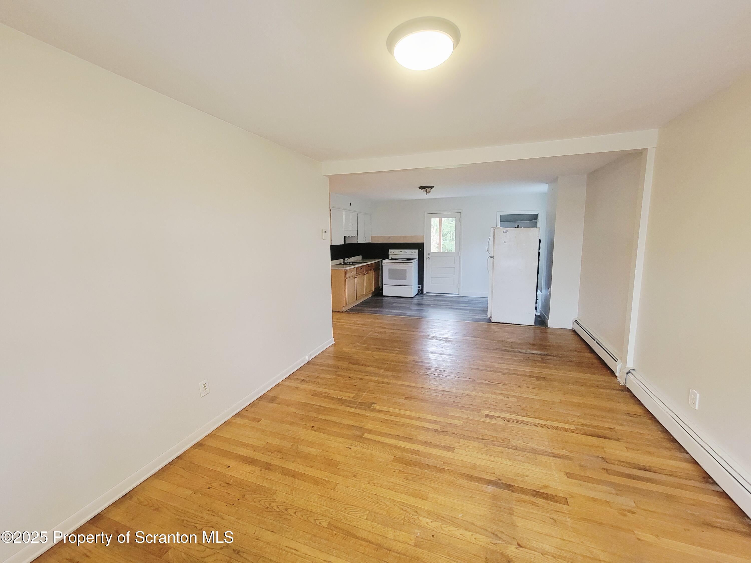 940 East Elm Street Scranton, PA 18505 - Photo 3 of 10 a view of empty room with wooden floor
