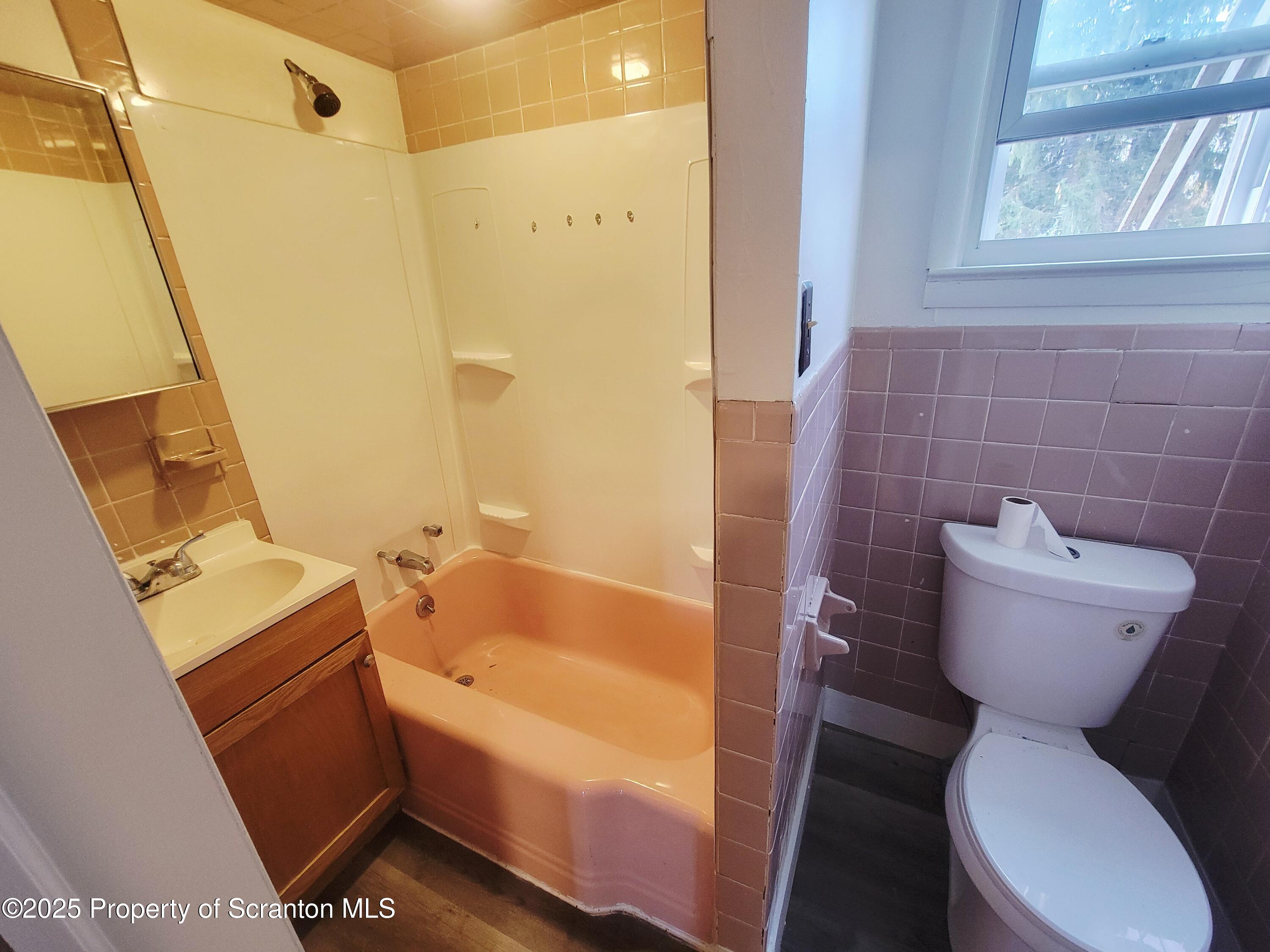 940 East Elm Street Scranton, PA 18505 - Photo 6 of 10 a bathroom with a toilet and a bathtub