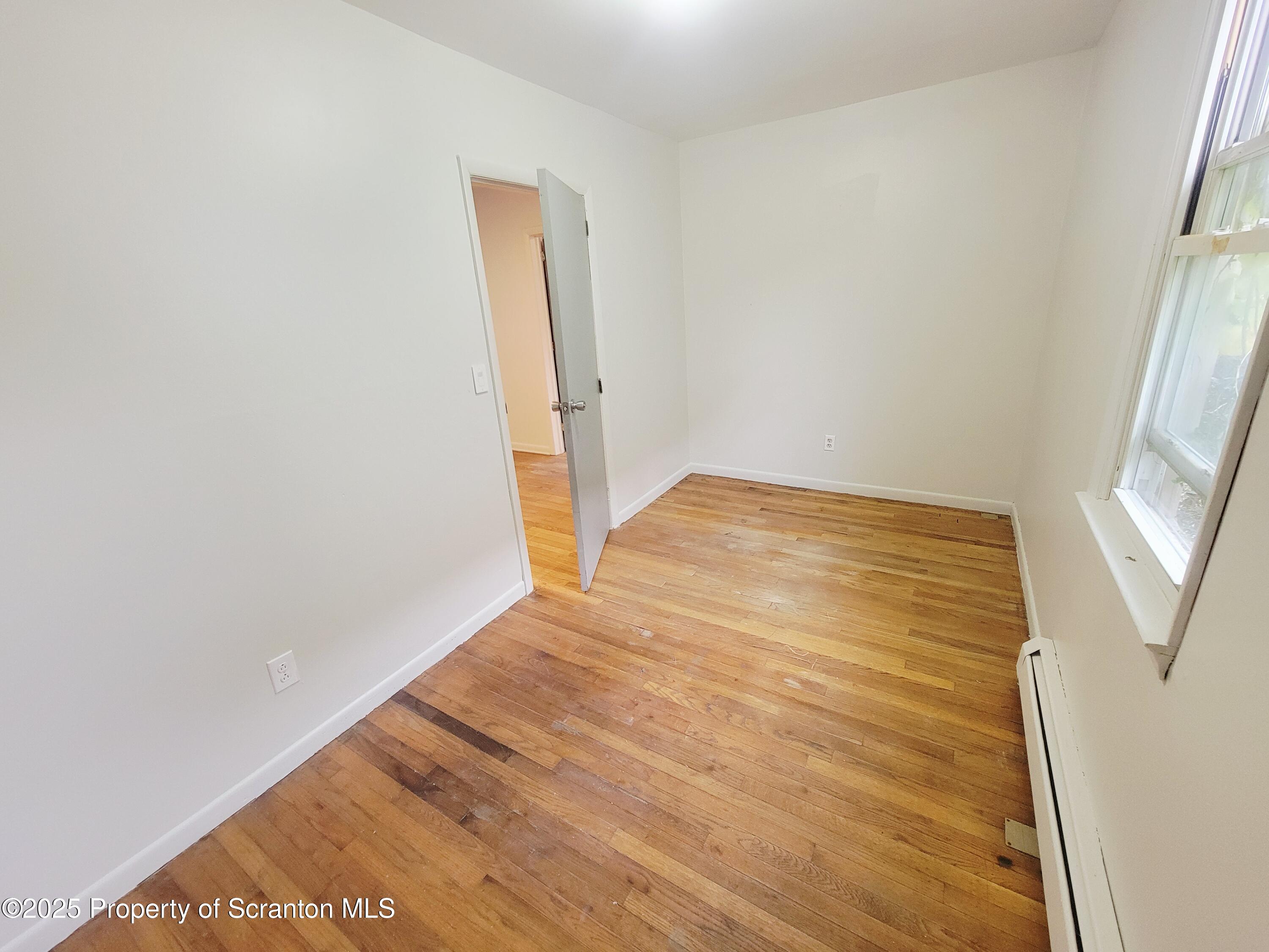 940 East Elm Street Scranton, PA 18505 - Photo 8 of 10 a view of empty room with wooden floor