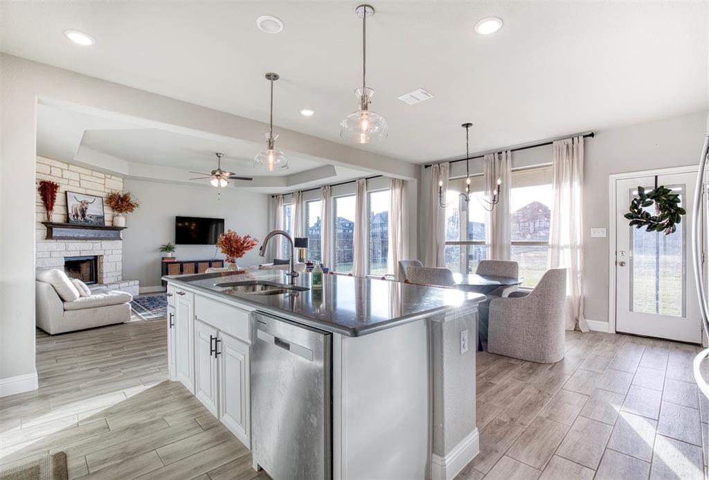 12605 Eagles Bluff Godley, TX 76044 - Photo 12 of 39 a kitchen with stainless steel appliances granite countertop a stove oven and a view of living room