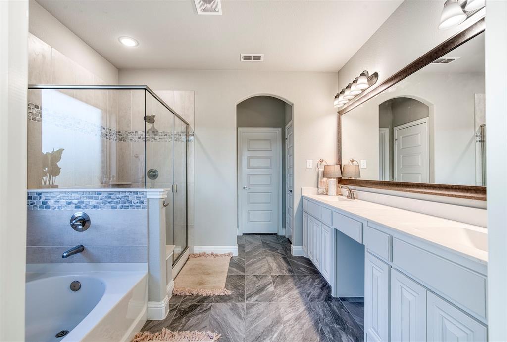 12605 Eagles Bluff Godley, TX 76044 - Photo 19 of 39 a bathroom with a double vanity sink a large mirror and shower