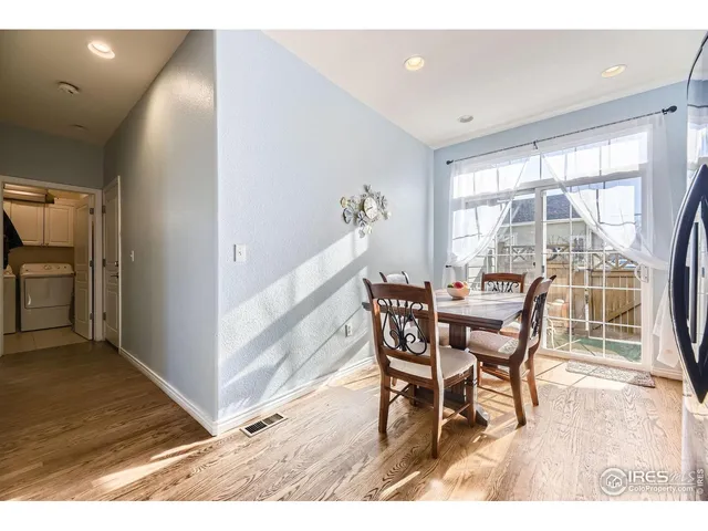a dining room with furniture and wooden floor